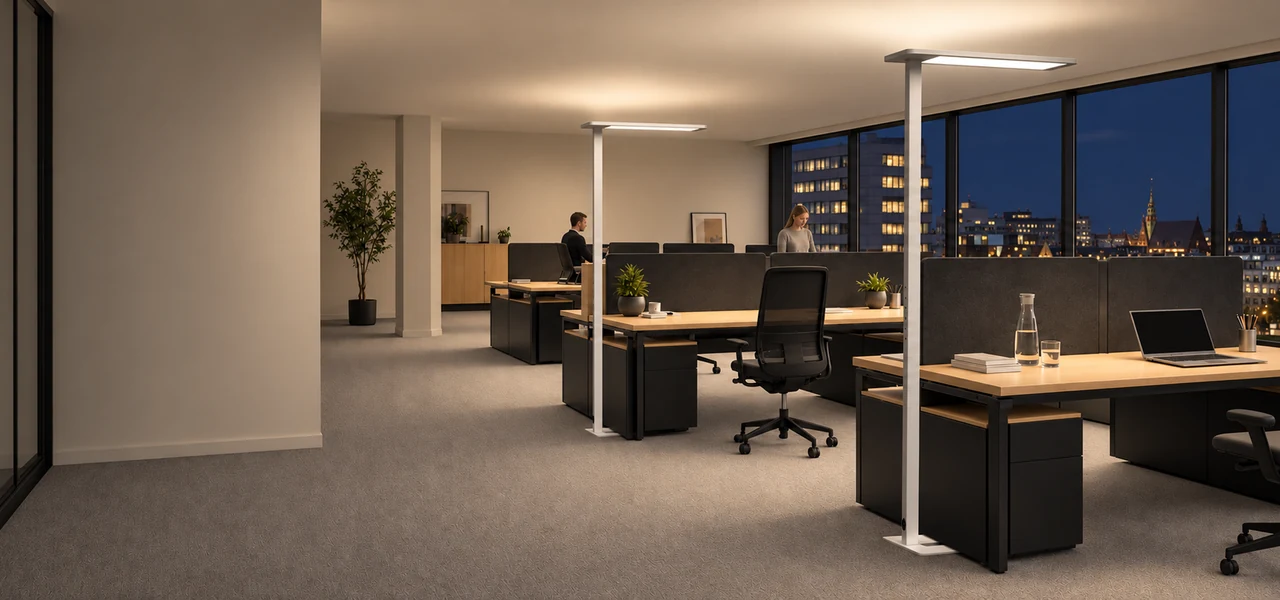 White office floor lamps illuminating shared desks in the evening