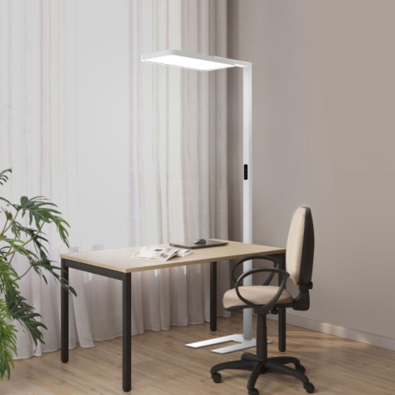 A white luminaire beside a wood-topped desk and office chair